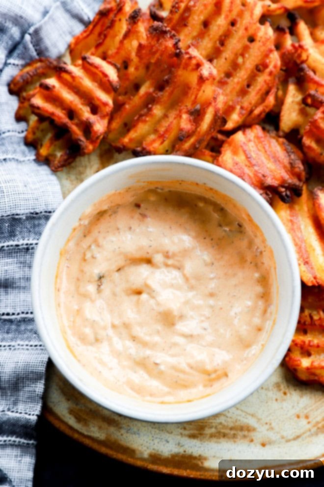 Bold Chipotle Aioli 8 Bowl of chipotle aioli with waffle fries on platter with linen napkin