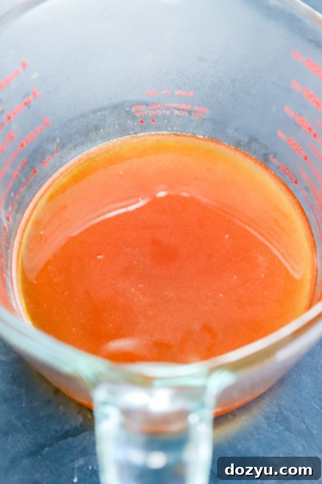 Sweet Heat Honey 5 strained hot honey in a measuring cup