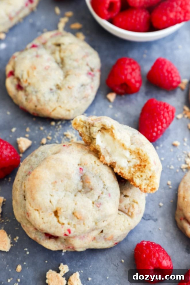 Raspberry Cheesecake Cookie Fusion 7 raspberry cheesecake cookies in a stack with fresh raspberries