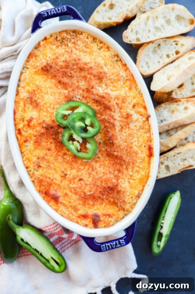 Zingy Cheesy Jalapeno Spread 2 baked jalapeno popper dip with jalapeno slices on top