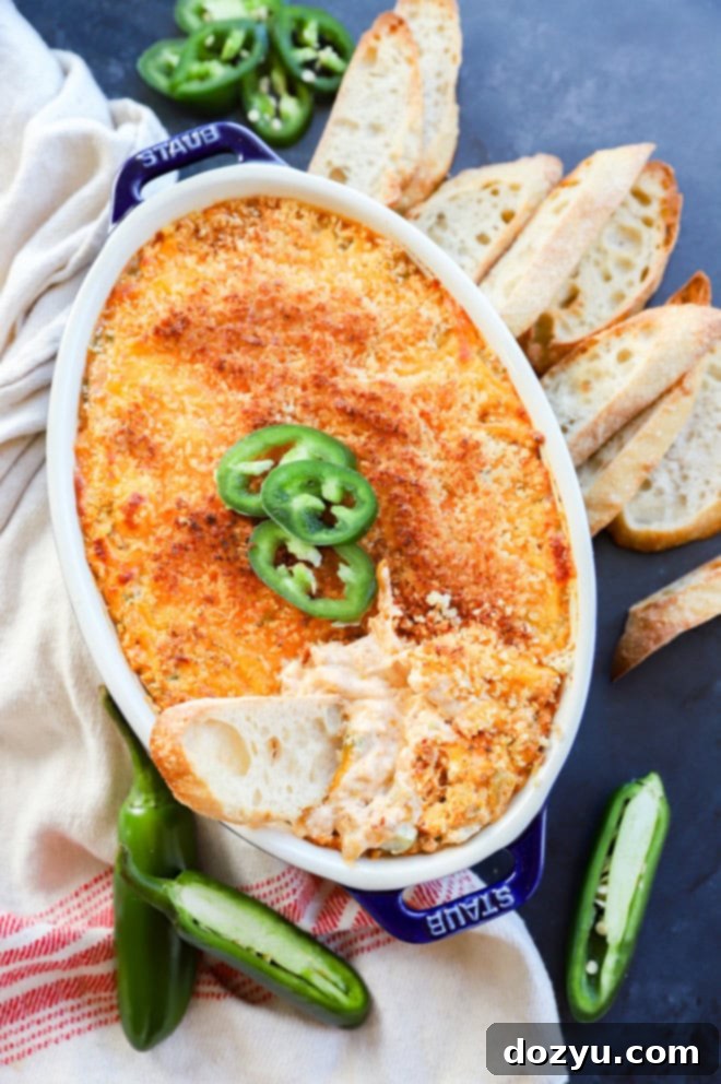 Zingy Cheesy Jalapeno Spread 7 bread slice in a pan of jalapeno popper dip