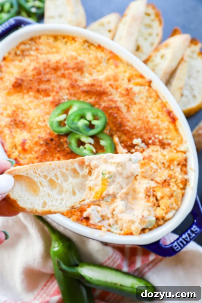 Zingy Cheesy Jalapeno Spread 9 hand holding bread slice with creamy cheese dip on it
