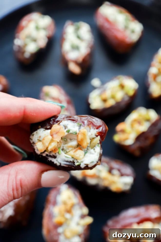 Elevate Your Dates: 4 Irresistible Stuffings 12 A hand holding a beautifully stuffed date, showcasing the rich filling