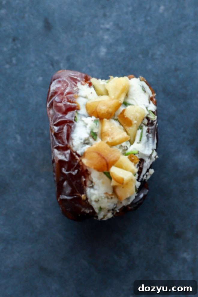 Elevate Your Dates: 4 Irresistible Stuffings 5 A close-up of a goat cheese and rosemary stuffed date, garnished with a walnut