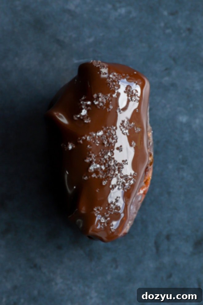 Elevate Your Dates: 4 Irresistible Stuffings 7 A chocolate-covered nut butter stuffed date, sprinkled with flaky sea salt