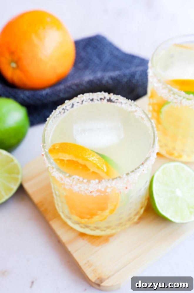 The Patron Margarita 3 Citrus slices in a cocktail glass with drink with fresh lime and orange