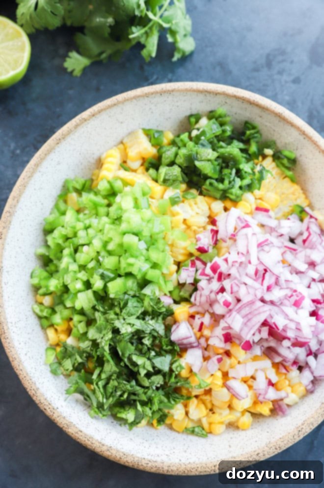 Smoky Roasted Corn Salsa 5 roasted chili corn salsa in a bowl before stirring it all together