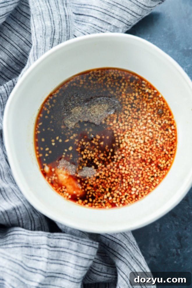 Sweet & Sticky Honey Soy Marinade 2 A bowl filled with homemade honey soy marinade, ready for use, against a warm kitchen backdrop.