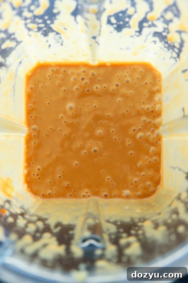 Creamy Thai Peanut Dressing 4 Thai peanut dressing being blended in a high-speed blender