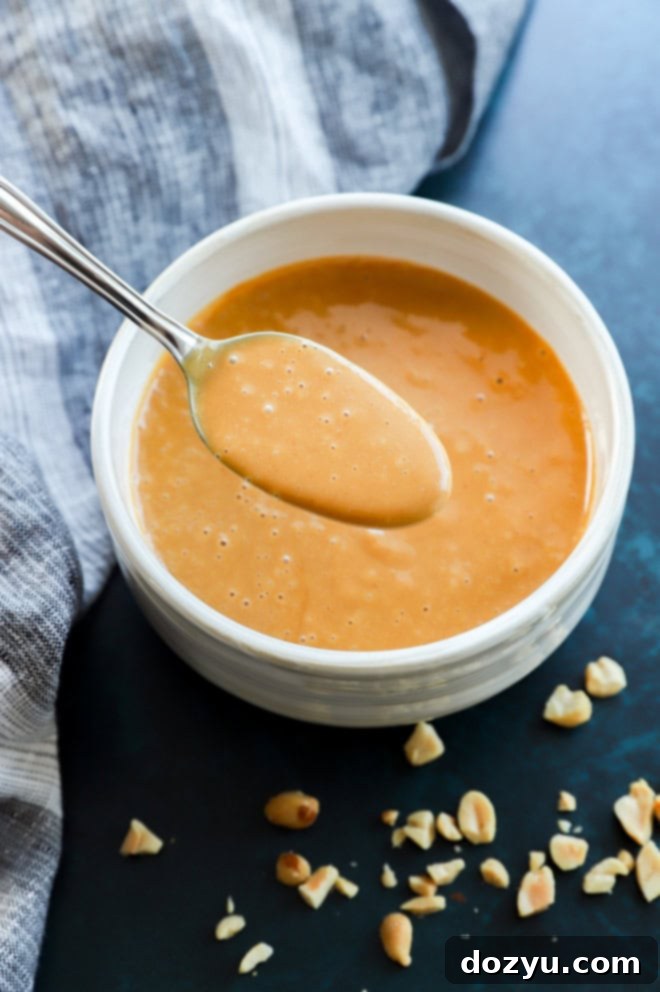 Creamy Thai Peanut Dressing 5 A spoonful of rich, creamy Thai peanut dressing in a bowl