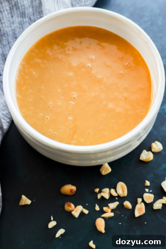 Creamy Thai Peanut Dressing 6 Bowl of creamy Asian-inspired sauce with peanuts scattered around it