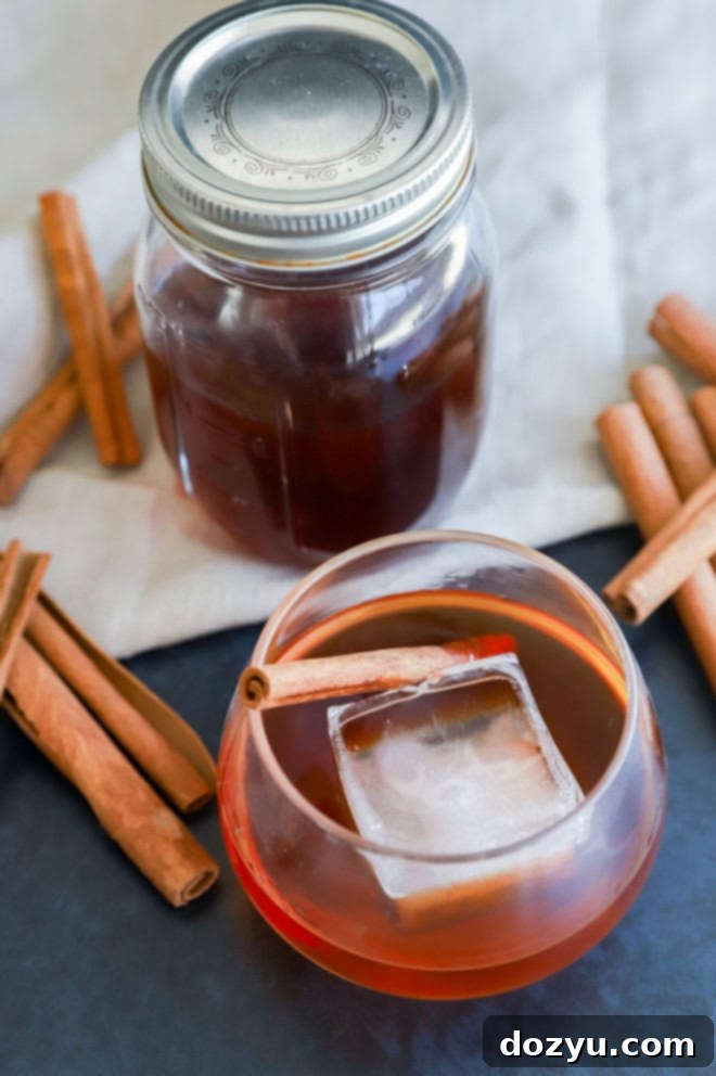 Bespoke Cinnamon Spirit 3 cinnamon whiskey in a glass with an ice cube image