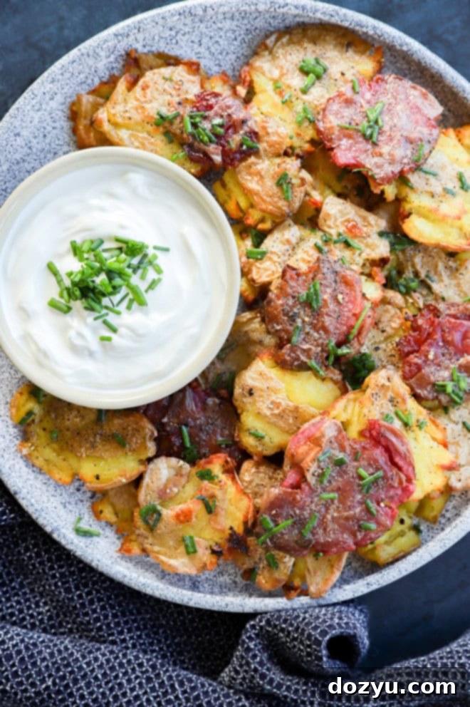 Golden Crispy Smashed Potatoes 2 easy spud side side or appetizer on platter with sour cream