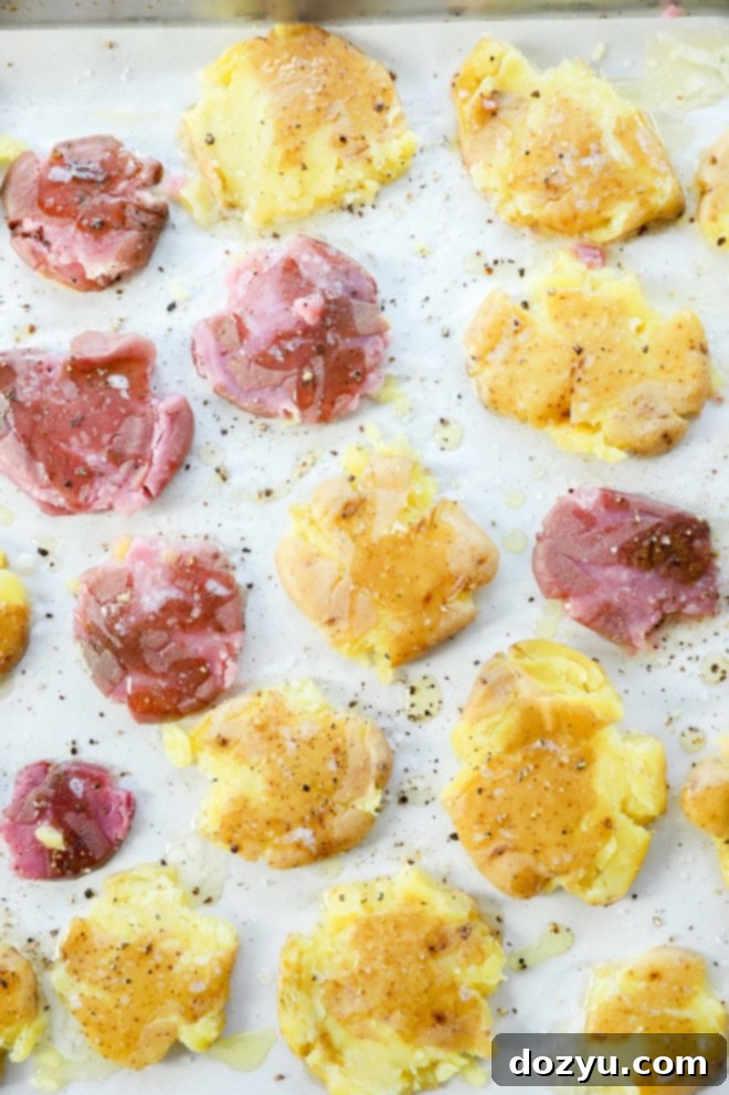 Golden Crispy Smashed Potatoes 5 smashed potatoes on a baking sheet before baking