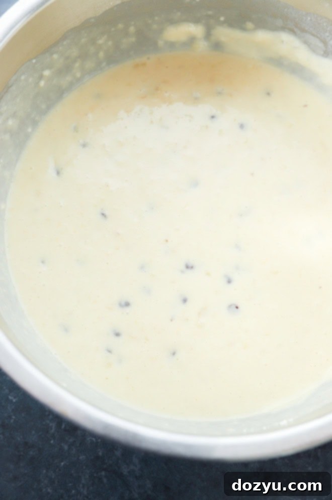 Ultimate Banana Chocolate Chip Waffles 4 Banana chocolate chip waffle batter in a large mixing bowl, ready to be cooked