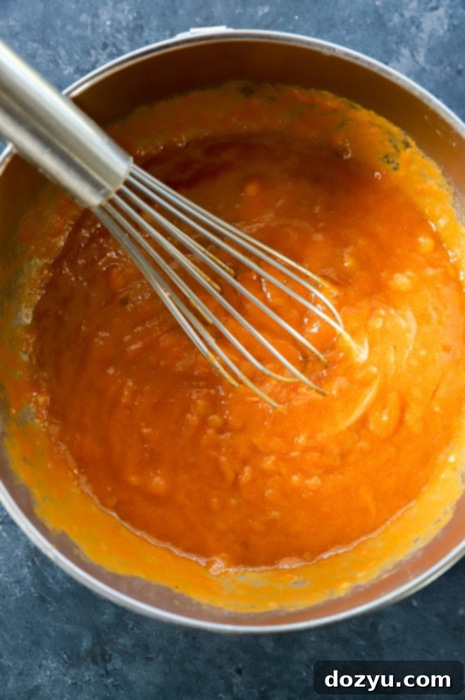 Spiced Pumpkin Banana Muffins 7 pumpkin puree wet ingredients in bowl with whisk