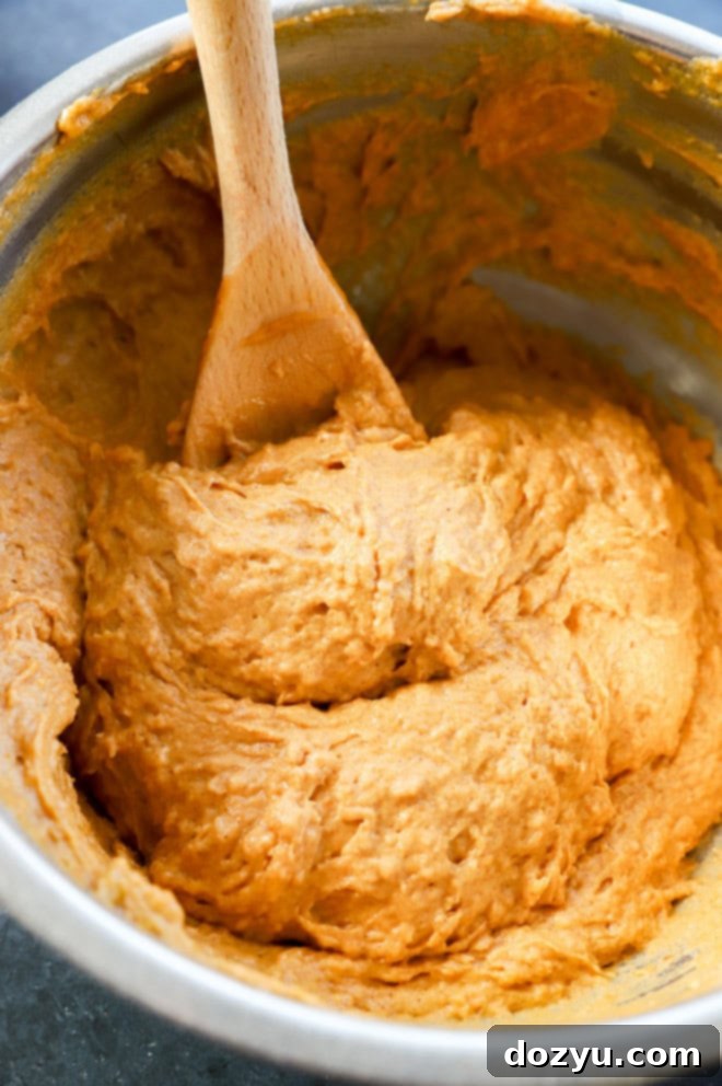 Spiced Pumpkin Banana Muffins 8 pumpkin banana muffin batter in bowl with wooden spoon