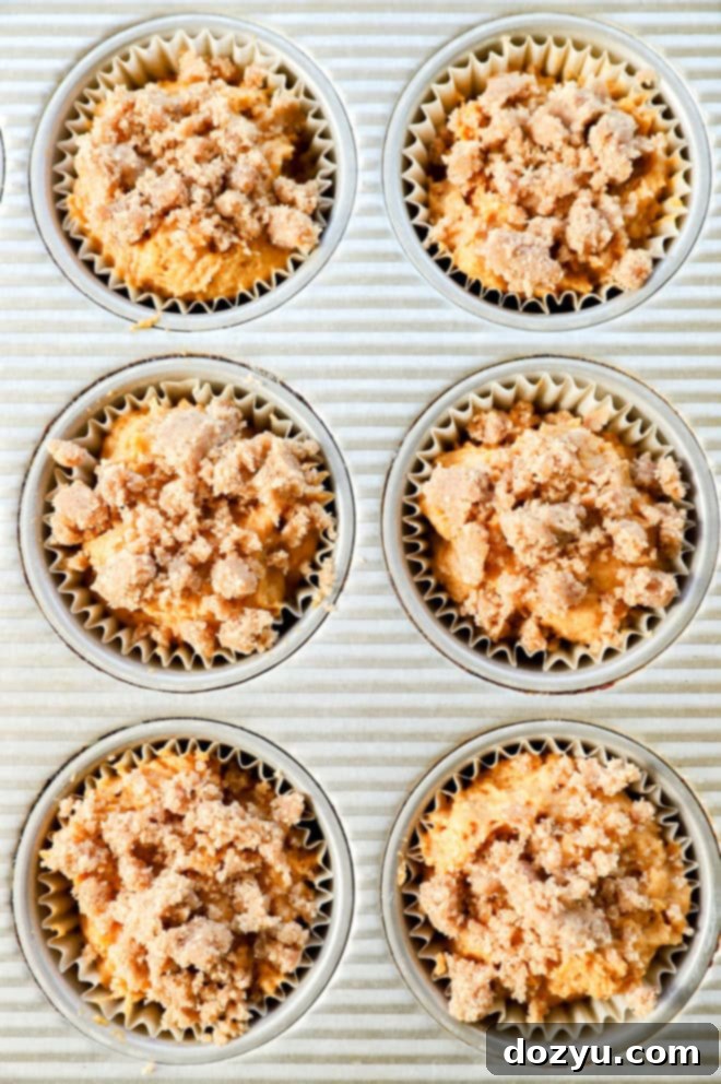 Spiced Pumpkin Banana Muffins 9 pumpkin banana muffins in muffin tin before baking