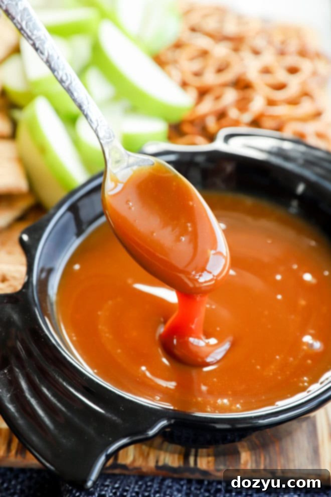 Caramel Apple Delight 2 Gooey caramel apple dip on a spoon over a bat-shaped bowl, ready for dipping