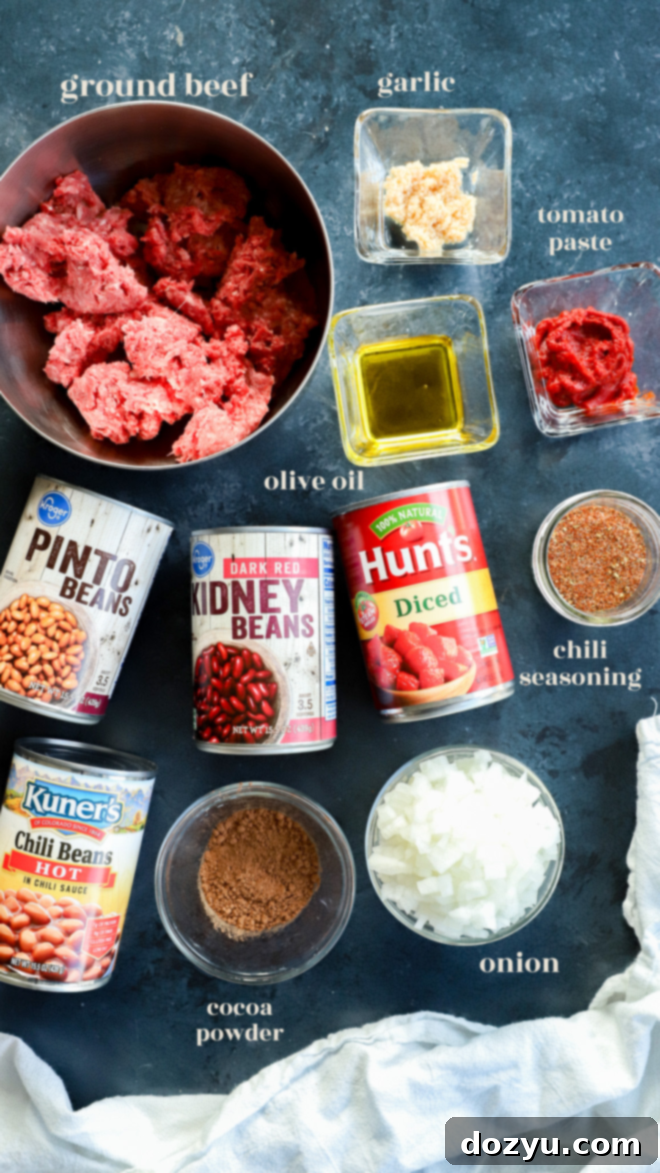 Effortless Instant Pot Chili 3 Ingredients for Instant Pot Chili laid out in bowls with text labels, including diced onion, garlic, ground beef, beans, tomatoes, and various spices.