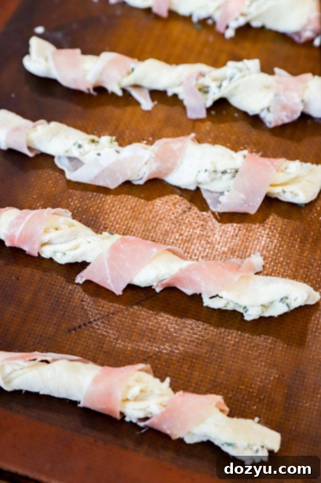 Savory Prosciutto Swirls 5 preppe prosciutto cheese twists on baking sheet before baking