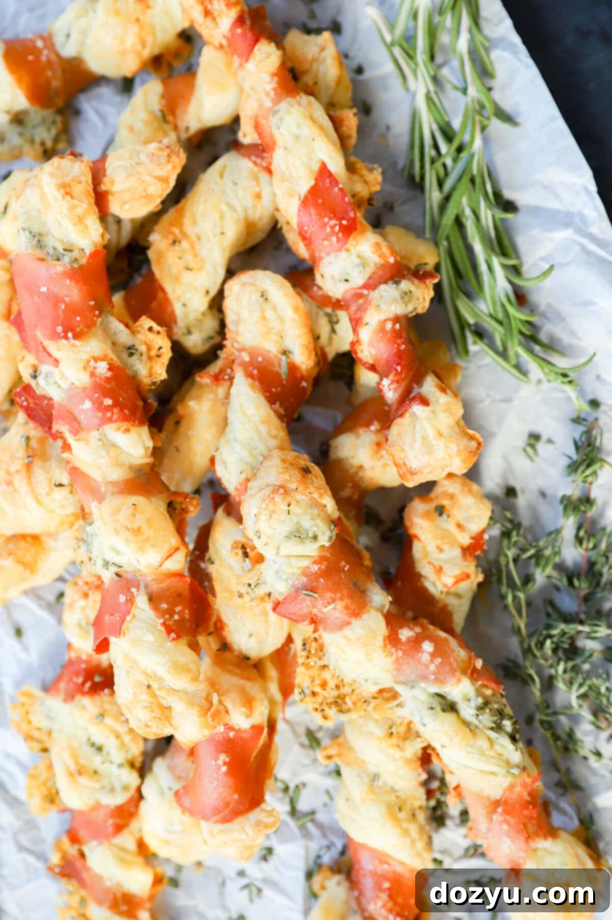 Savory Prosciutto Swirls 10 easy puff pastry italian appetizer on parchment paper with fresh herbs