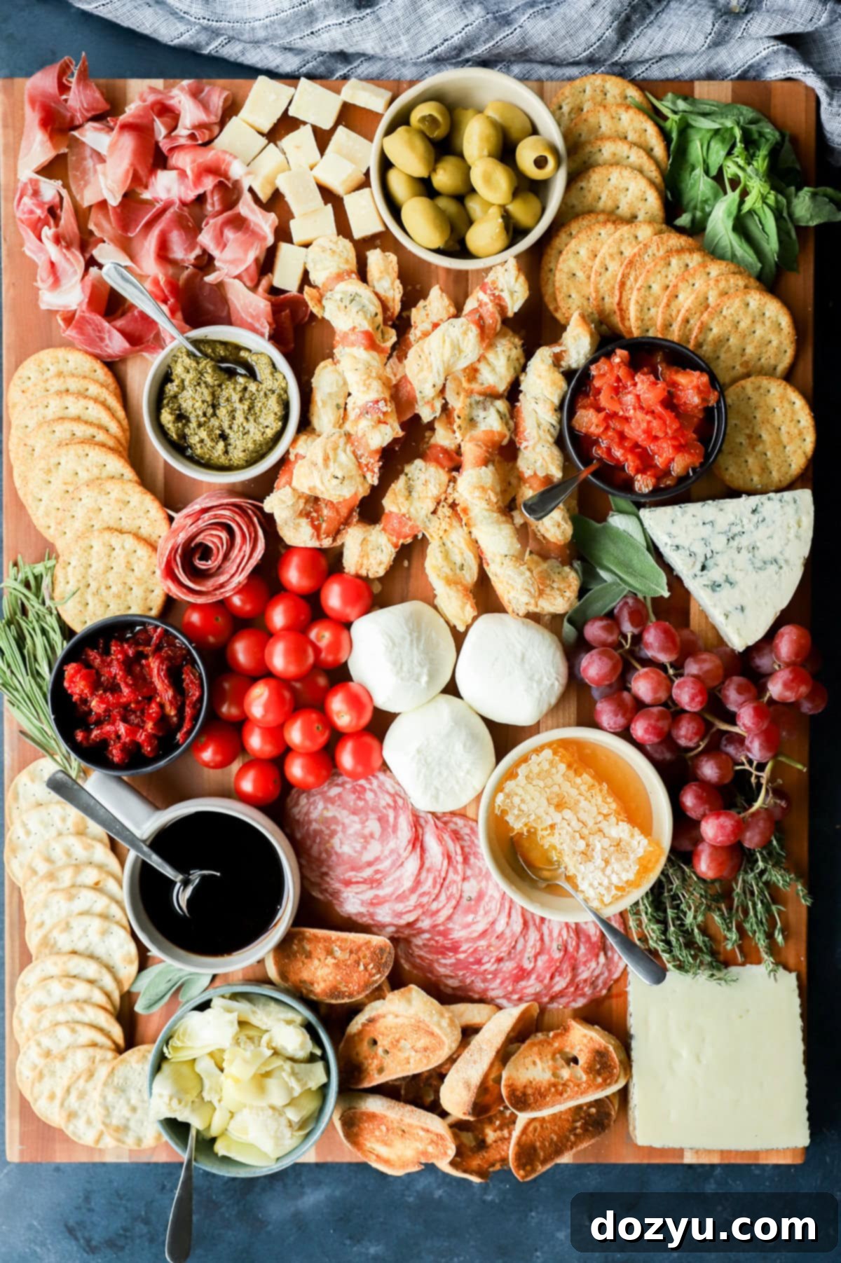 The Ultimate Italian Grazing Board 11 easy meat and cheese spread on cutting board with fresh produce