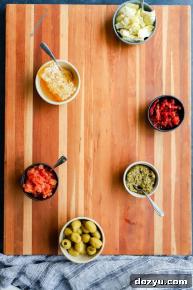 The Ultimate Italian Grazing Board 5 bowls on cutting board platter for italian charcuterie board assembly