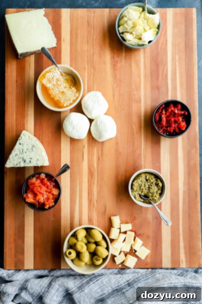 The Ultimate Italian Grazing Board 6 cheese added to cutting board for appetizer spread