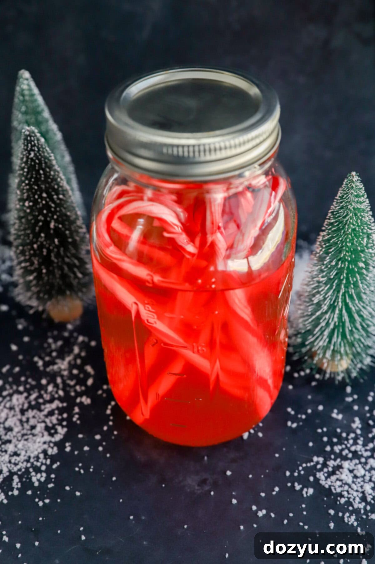 Handcrafted Peppermint Vodka 8 candy cane liquor in bottle with candies and fake snow