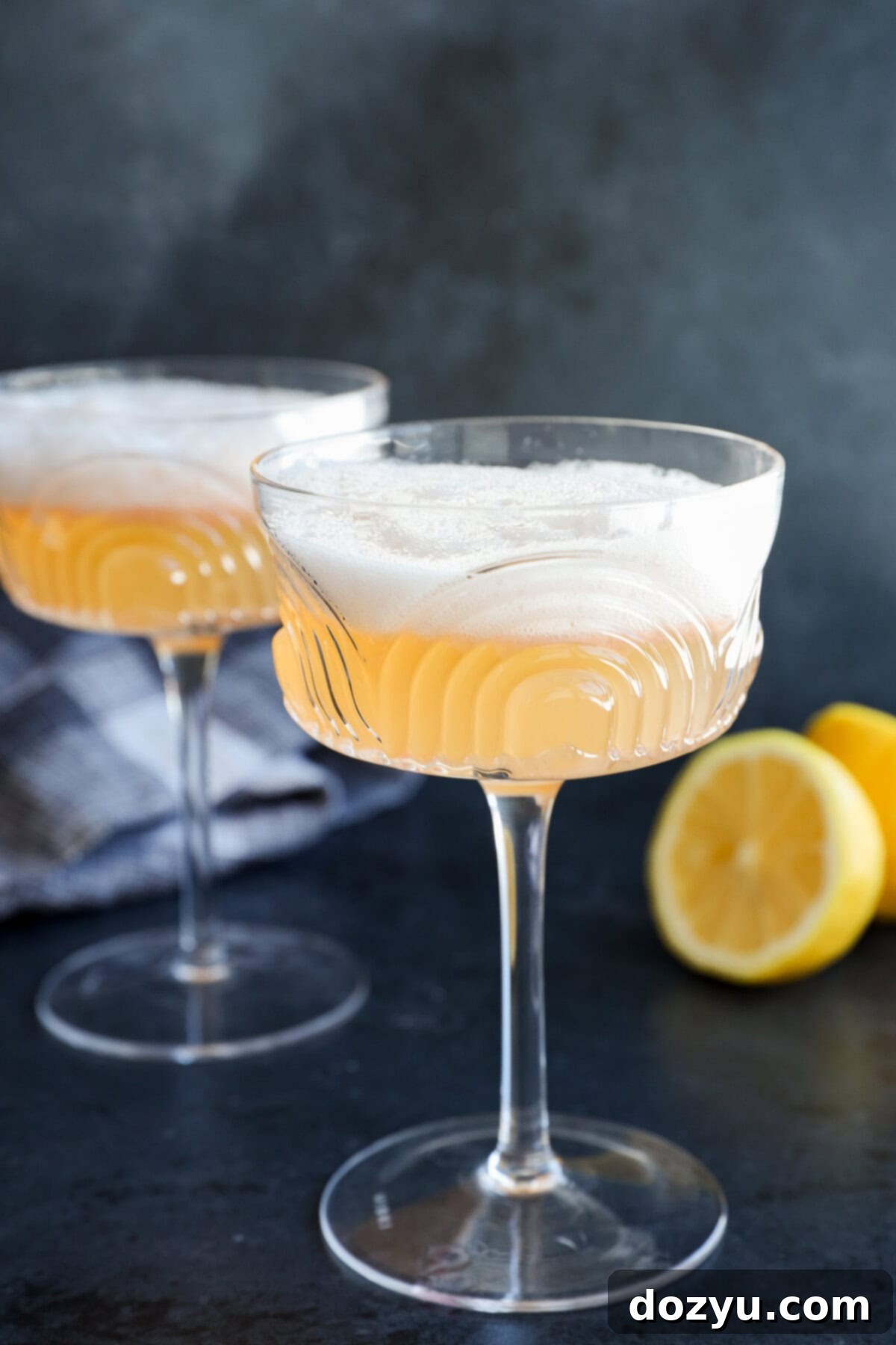 Classic Gin Sour Cocktail 7 Two easy cocktails in coupe glasses, garnished with lemon halves