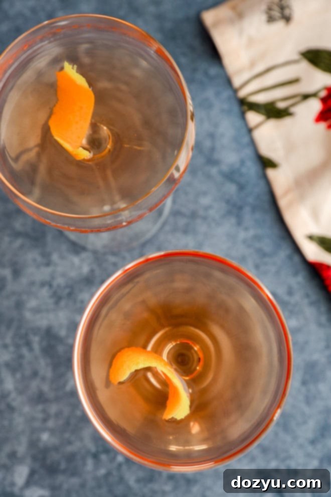 Rose Gin Elixir 7 overhead image with cocktails in coupe glasses with lemon twists