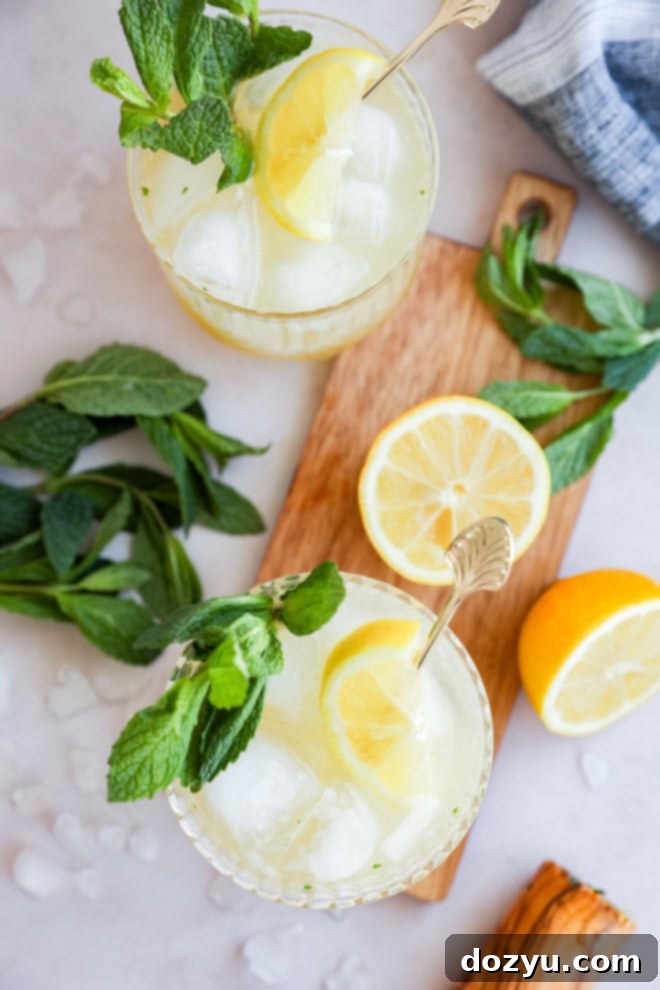 Refreshing Bourbon Smash 2 image of lemon cocktail in glasses with fresh mint and cutting board