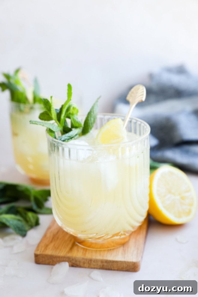 Refreshing Bourbon Smash 3 easy lemon cocktail with mint and lemons on cutting board