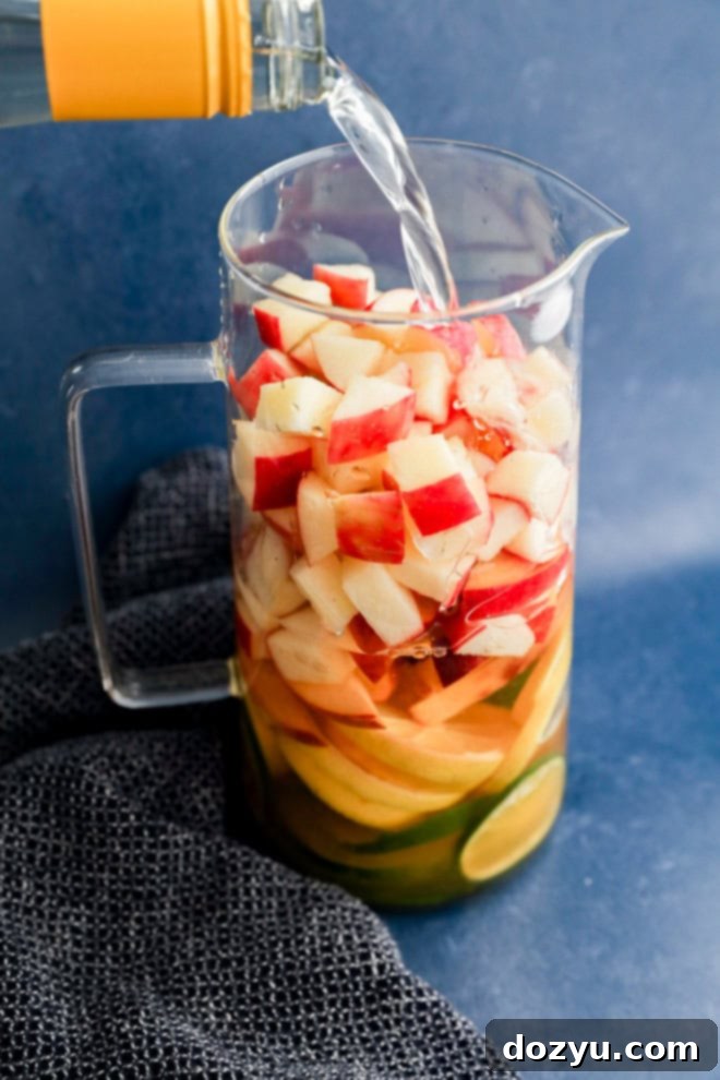 Crisp White Sangria Delight 4 pouring wine into a pitcher with fresh fruit