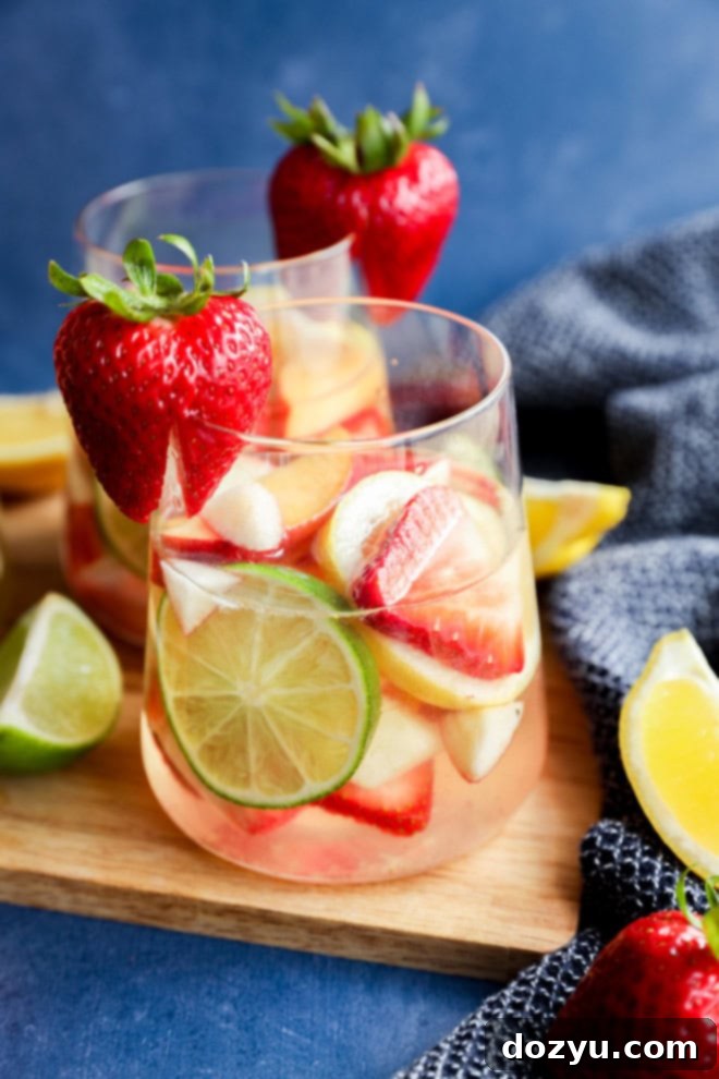 Crisp White Sangria Delight 8 fresh fruit in a glass with wine on a wooden cutting board
