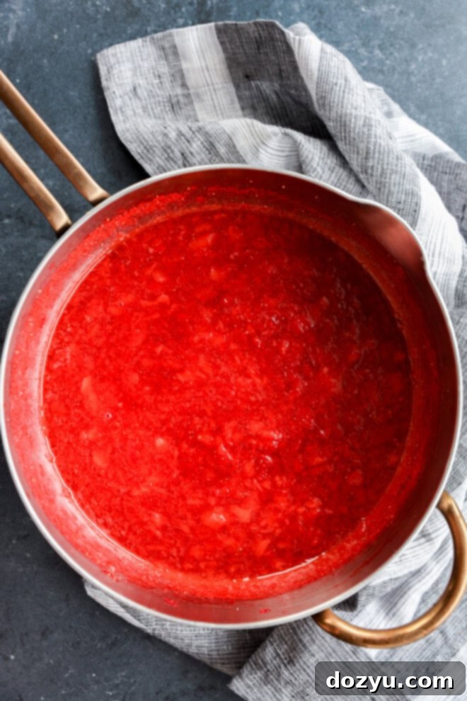 Luscious Strawberry Filling 5 saucepan of cooling berry compote with linen