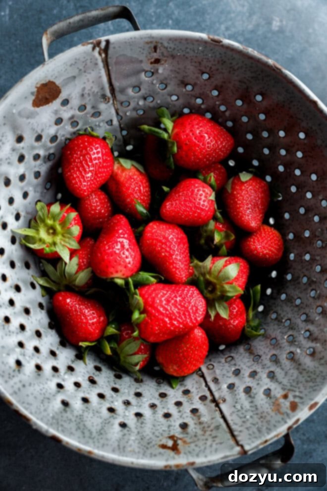 colander of fresh strawberries freshly washed