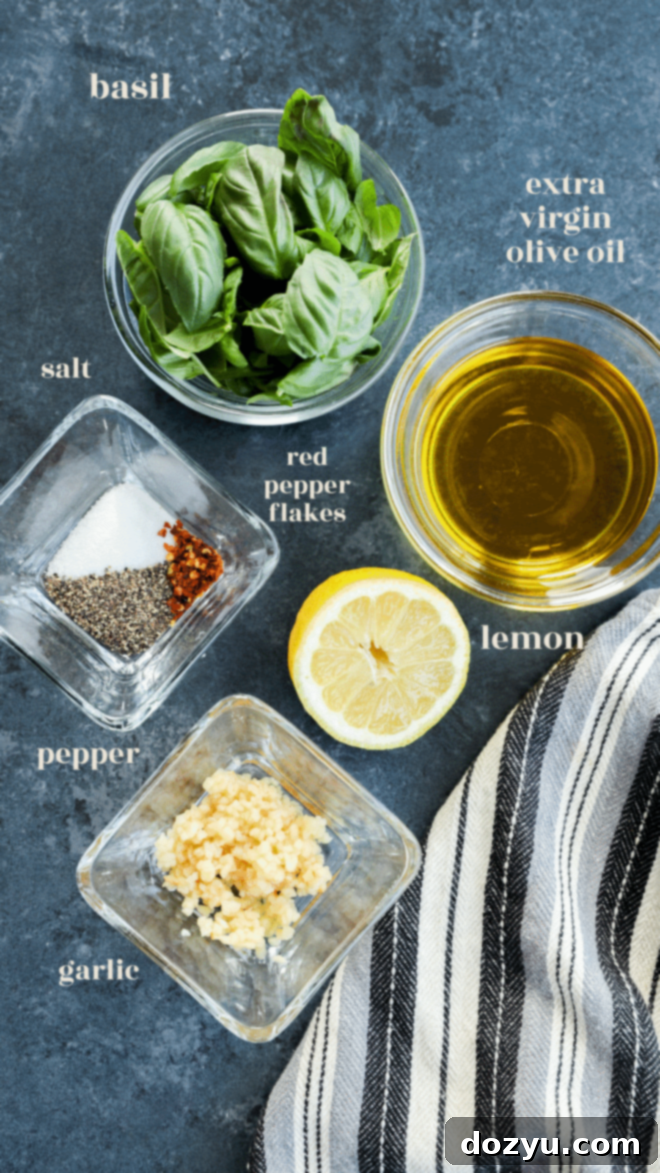 The Magic of Basil Oil 3 Individual bowls showcasing the fresh basil leaves, extra virgin olive oil, garlic cloves, and a lemon, all labeled as key ingredients for making basil oil.