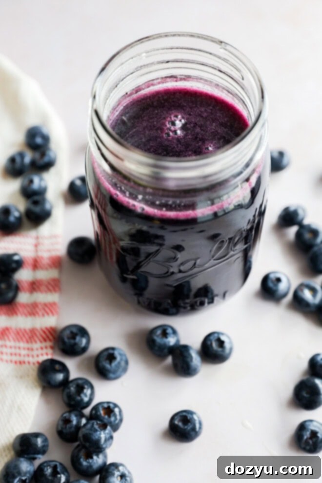 Luscious Blueberry Syrup 2 jar of sugar mixture with fresh berries all around and linen
