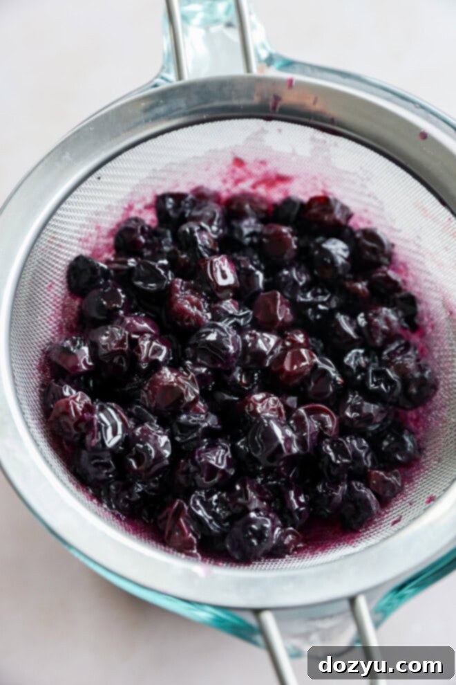 Luscious Blueberry Syrup 5 strained blueberries in sieve