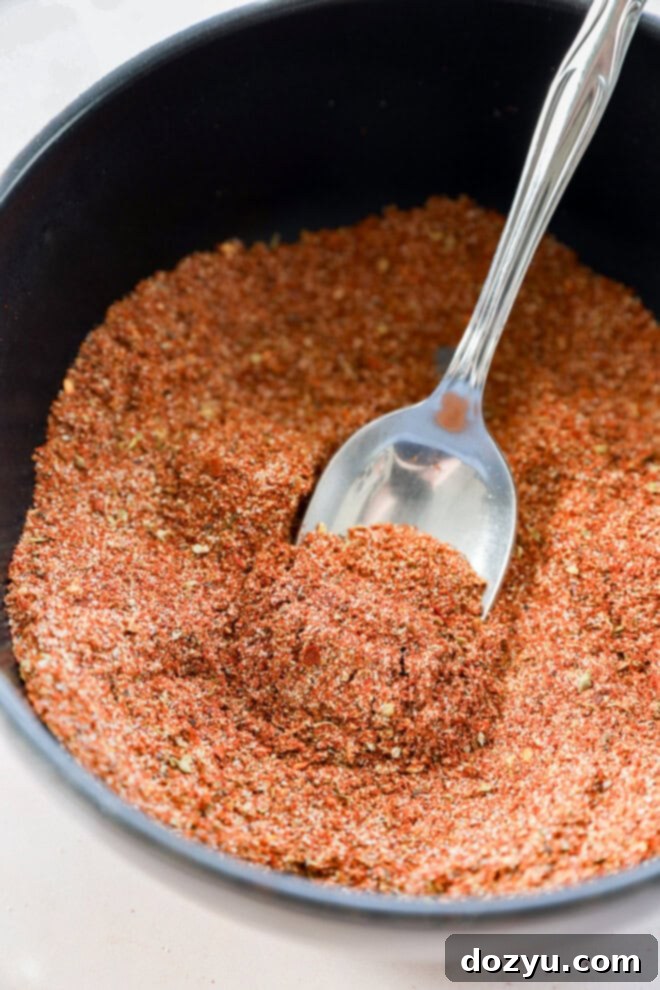 Southwest Mesa Blend 4 Someone stirring a bowl of Southwest spice mix ingredients to combine them thoroughly.