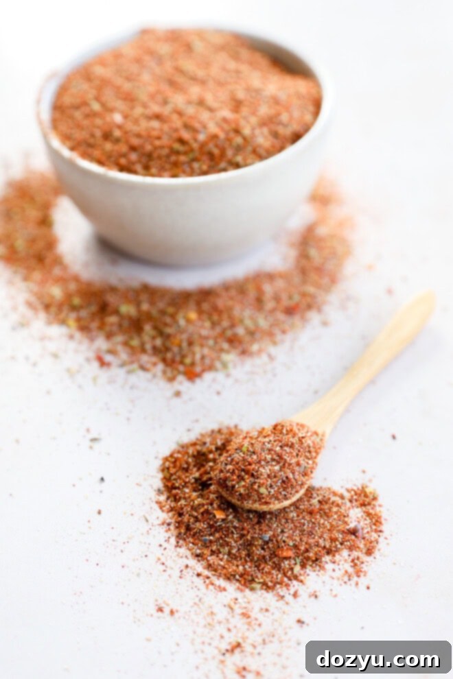 Southwest Mesa Blend 5 Southwest spice mix in a bowl with a small wooden spoon for serving, highlighting its rich color and texture.