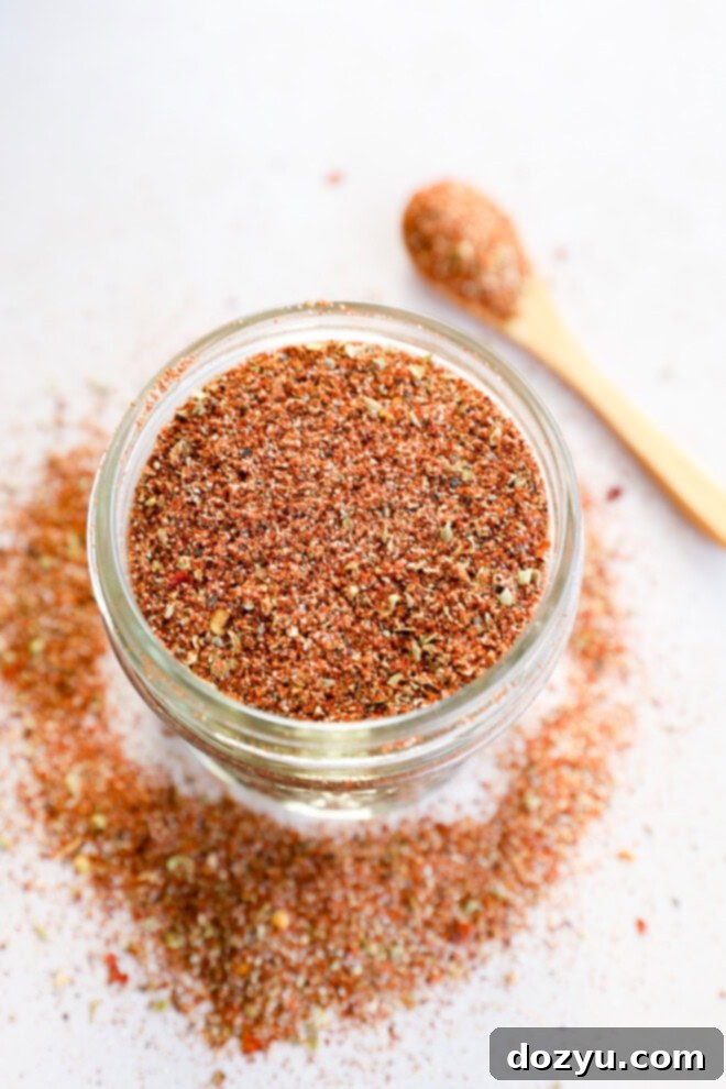 Southwest Mesa Blend 6 A mason jar filled with Southwest spice mix, with a small silver spoon partially visible in the blurred background.