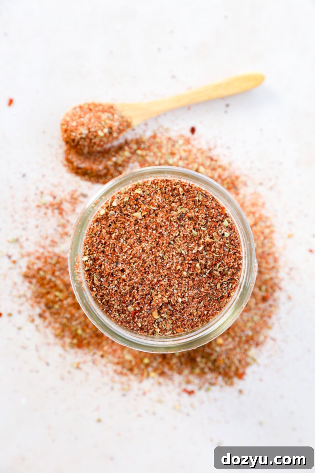 Southwest Mesa Blend 8 A mason jar filled with rich, reddish-brown Southwest Spice Mix, with a small spoon resting beside it, ready for use.