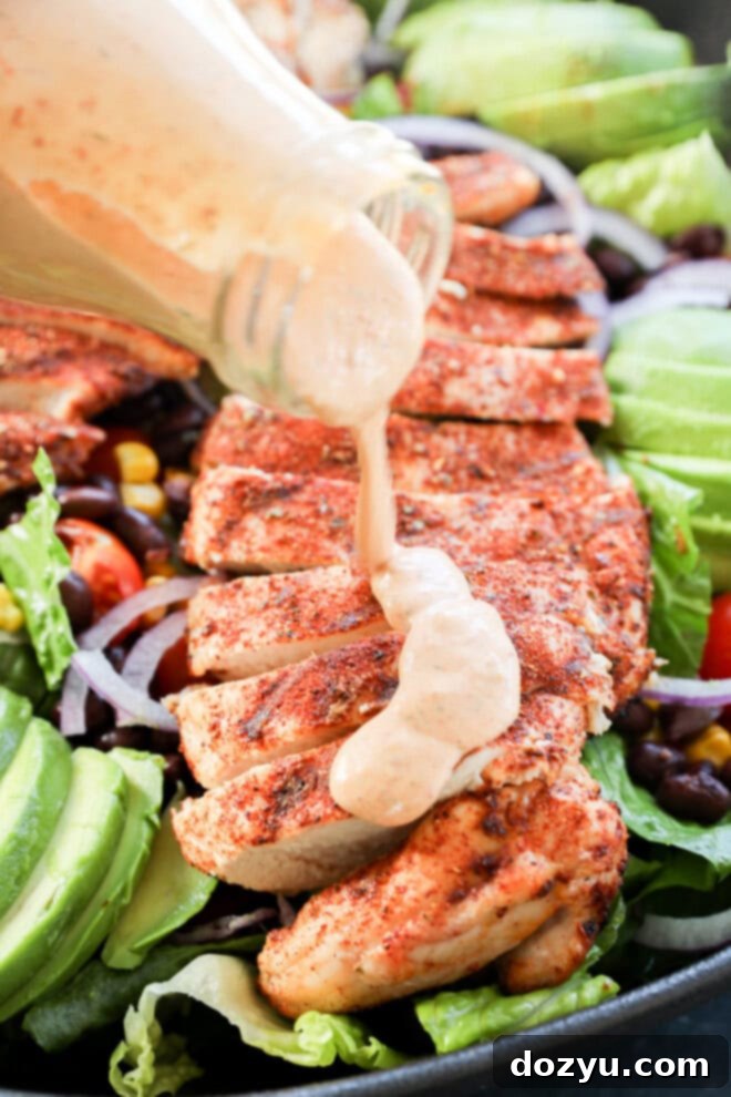 Fiesta Chicken Salad 6 pouring dressing on top of seasoned grilled poultry
