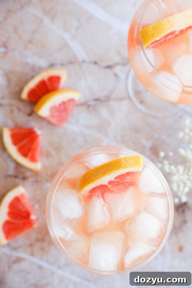Rosé Elderflower Spritz 5 Wine elderflower drink in a stemmed wine glass with fresh grapefruit and baby's breath