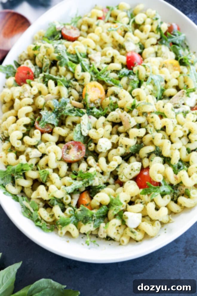 Zesty Pesto Chicken Pasta Salad 8 pesto chicken pasta salad in a large white serving bowl on black counter