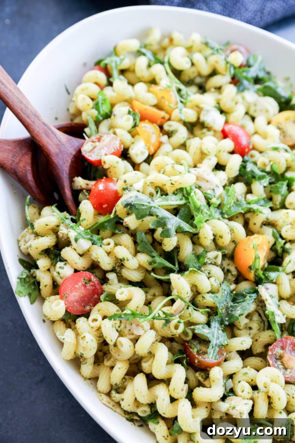 Zesty Pesto Chicken Pasta Salad 9 close up of pasta tossed with pesto and other fresh ingredients