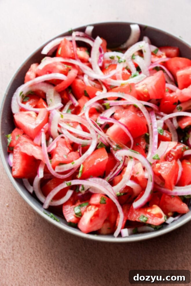 Zesty Tomato Onion Salad 5 Simple picnic vegetable side dish in a bowl with fresh herbs